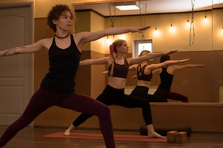 A yoga class taking place in a heated, steam-filled studio