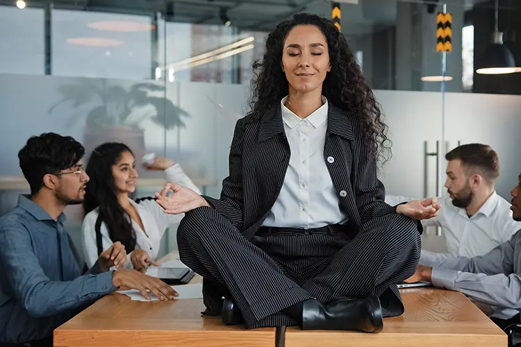 An employee taking a moment to breathe and reset at their desk during a busy workday
