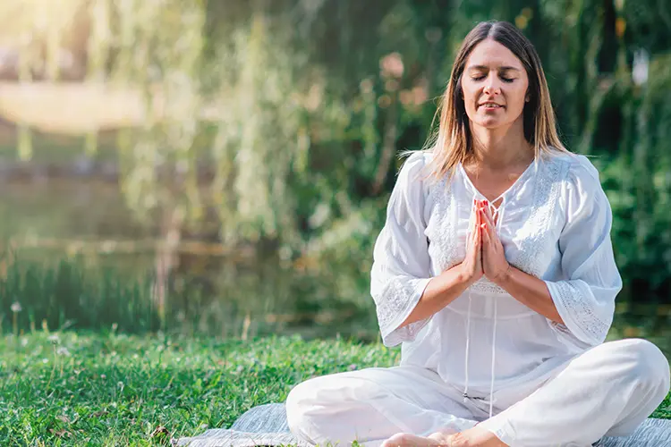 A yoga class moving slowly through a foundational pose sequence